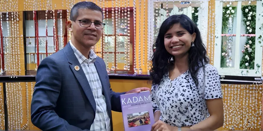 Dr. Aditi Pajiyar and Dr. Shreedhar Paudel holding a copy of his book Kadam: Quest for Global Health Innovation in Nepal